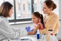 mother vaccinating her little daughter at clinic Royalty Free Stock Photo