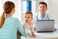 Woman with baby and doctor with laptop at clinic Royalty Free Stock Photo