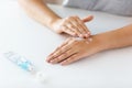 Close up of hands with cream or therapeutic salve