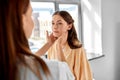 doctor checking lymph nodes of woman at hospital