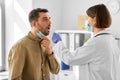 doctor checking male patient& x27;s throat at hospital Royalty Free Stock Photo