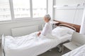 Lonely senior woman sitting in bed at hospital Royalty Free Stock Photo