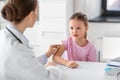 doctor preparing girl patient for vaccination