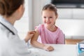 doctor preparing girl patient for vaccination