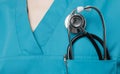 Medicine, insurance and healthcare concept. Stethoscope in surgeon doctor pocket green coat, close-up Royalty Free Stock Photo