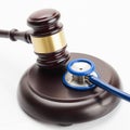 Medicine and medical symbols - close up shot of a wooden judge gavel and a stethoscope