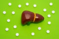 Anatomy and treatment of liver, gallbladder and biliary tract in concept photo on green background with polka dots and pills. Med