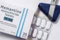 Medicine Memantine. Open packaging box with pills in blister with international chemical generic name of drug Memantine for treatm