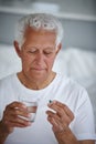 Medicine on the menu. a senior man taking his medicine. Royalty Free Stock Photo