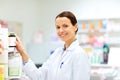 Happy female apothecary with drug at pharmacy Royalty Free Stock Photo