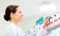 Happy female apothecary with drug at pharmacy Royalty Free Stock Photo