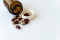 Medicine and pills. Medicines on a white background close-up. Brown glass bucket with capsules inside on a white Royalty Free Stock Photo