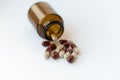 Medicine and pills. Medicines on a white background close-up. Brown glass bucket with capsules inside on a white Royalty Free Stock Photo