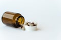 Medicine and pills. Medicines on a white background close-up. Brown glass bucket with capsules inside on a white Royalty Free Stock Photo