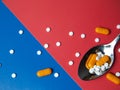 medicine pills, tablets and capsules. Blue and red background. Heap of assorted various medicine tablets and pills on spoon Royalty Free Stock Photo