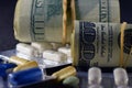 Medicine pills and US dollars