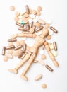 Medicine prescription. Wooden human dummy lay on pile of pills and tablets. Take medicine concept. Health and treatment Royalty Free Stock Photo