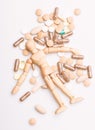 Medicine prescription. Wooden human dummy lay on pile of pills and tablets. Take medicine concept. Health and treatment