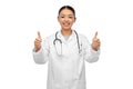 Smiling asian female doctor showing thumbs up Royalty Free Stock Photo