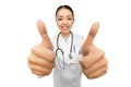 Smiling asian female doctor showing thumbs up Royalty Free Stock Photo