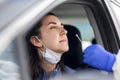 Healthcare worker making coronavirus test at car