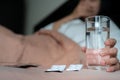 Medicine with sick women hand hold a glass of water, healthcare and medicine recovery concept - soft focus