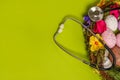 Medicine stethoscope with Easter eggs on spring green background. easter card with copy space Royalty Free Stock Photo