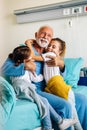 Happy grandchildren visiting grandfather at hospital ward. Support, family and healthcare concept. Royalty Free Stock Photo