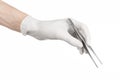 Medicine and Surgery theme: doctor's hand in a white glove holding tweezers isolated on white background Royalty Free Stock Photo