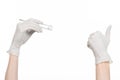 Medicine and Surgery theme: doctor's hand in a white glove holding tweezers with swab isolated on white background in studio Royalty Free Stock Photo