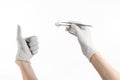 Medicine and Surgery theme: doctor's hand in a white glove holding tweezers with swab isolated on white background in studio Royalty Free Stock Photo