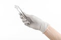 Medicine and Surgery theme: doctor's hand in a white glove holding tweezers with swab isolated on white background in studio Royalty Free Stock Photo