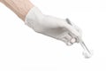 Medicine and Surgery theme: doctor's hand in a white glove holding tweezers with swab isolated on white background in studio Royalty Free Stock Photo