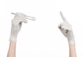 Medicine and Surgery theme: doctor's hand in a white glove holding tweezers with swab isolated on white background in studio Royalty Free Stock Photo