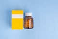 Medicine tablets bottle and box on a light blue background. Flat lay. Top view. Space for text. Medicine and treatment concept Royalty Free Stock Photo