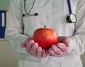 Medicine therapist hands holding red fresh ripe apple Royalty Free Stock Photo