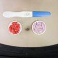 Medicine vitamin and pregnancy test on belly woman