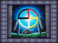 Medicine Wheel with feathers hanging and a land tortoise walking below. Native American canvas painting. Royalty Free Stock Photo