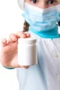 Medicine white pill bottle in the hand of female nurse, isolated on a white background Royalty Free Stock Photo