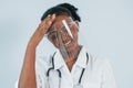 Medicine worker. Young african american woman is against white background