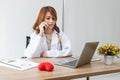 Medicine young Asian female doctor talking on the phone on workplace in hospital office. Health care and medical concept Royalty Free Stock Photo