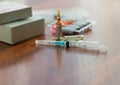 Medicines, injectable ampoules and syringe on the table