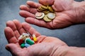 Medicines and money in human hands.