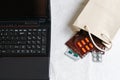 Medicines and pills next to laptop, notebook keyboard. Stress in the work, Anti virus