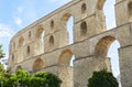 Medieval aqueduct on sunny summer day against blue sky. Ancient aqueduct Kamares, Kavala, eastern Macedonia, Greece