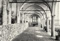 Medieval arcade corridor at Telc castle, black and white