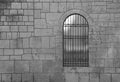 Medieval Arch Stone Blocks Castle Gate with Metal Lattice. black background. Stone wall with door protected by iron bars. wrought- Royalty Free Stock Photo