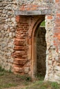 Medieval arched doorway in church ruins with handmade red bricks Royalty Free Stock Photo