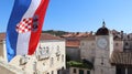 Croatian flag against the blue sky and the central square of Trogir Old town, Croatia Royalty Free Stock Photo