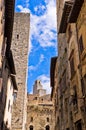 Medieval architecture of San Gimignano, towers and houses in narrow street, Tuscany